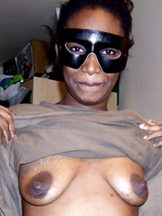 Ugly black female wearing a mask bares